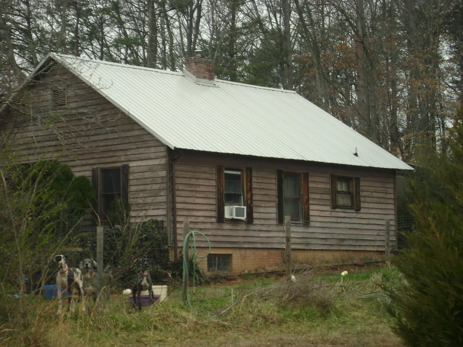 White metal roof on an old wood sided farmhouse, from a Metal Roof Installation job in Lowgap